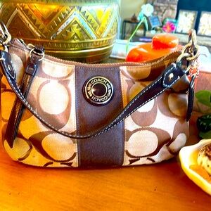 Coach shoulder bag signature “C” tan and brown. Silver accents . 10x6x2. GUC.